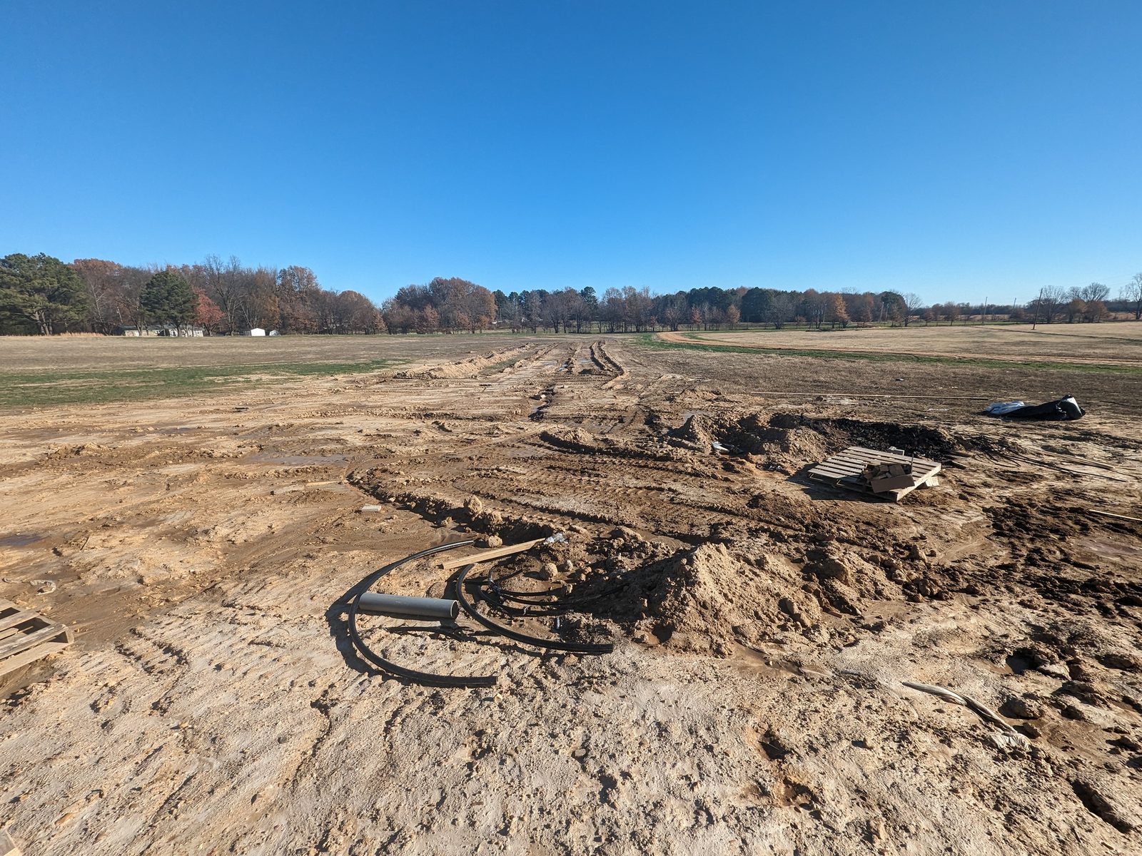 Coiled HDPE geothermal loop pipe ready to be laid in a trench
