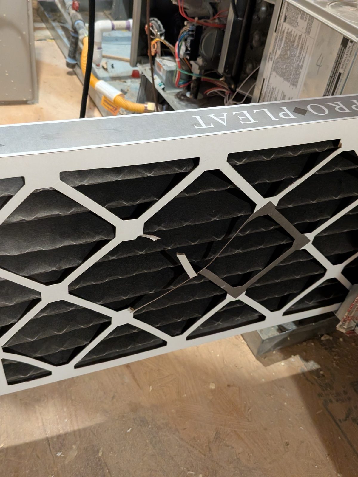 A badly clogged air filter pulled from a residential system during a service call