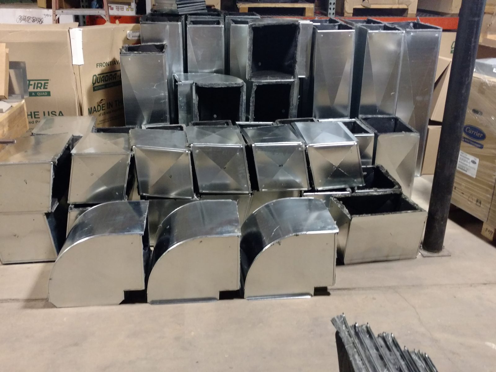 Custom sheet metal elbows and transitions fabricated in the shop, ready for a job